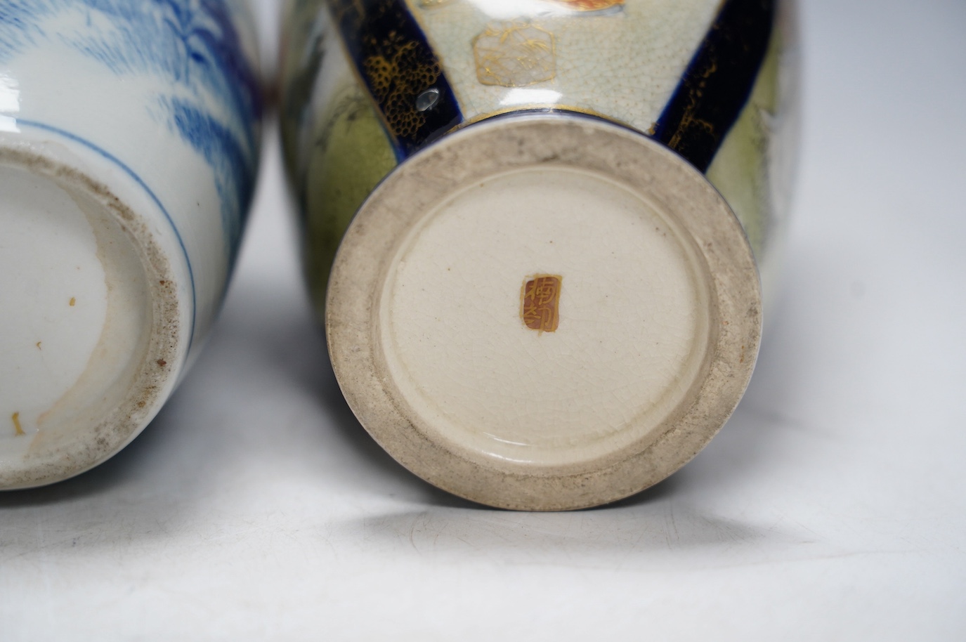 A pair of Japanese satsuma pottery vases and a blue and white Meiji Arita vase, largest 24cm high. Condition - fair